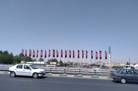 پرچم عزای حسینی بر پل فردیس نصب شد